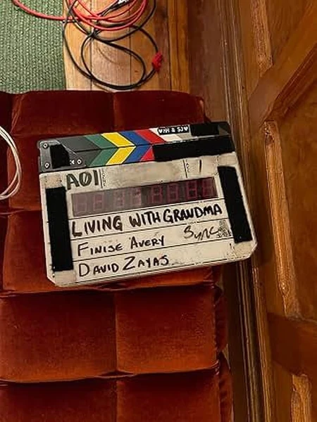 living-with-grandma-01 Living With Grandma clapperboard resting on a velvet armchair, showing the names of Finise Avery and David Zayas.